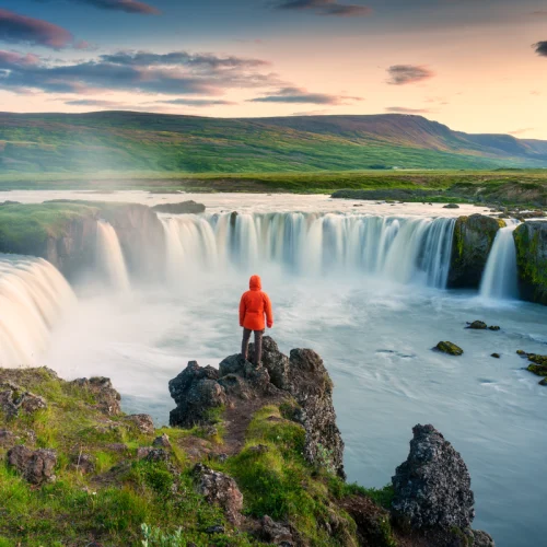 a-man-wearing-a-red-jackets-stands-near-the-edge-of-godafoss-waterfall-500x500 a-man-wearing-a-red-jackets-stands-near-the-edge-of-godafoss-waterfall-500x500
