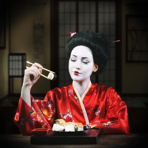Woman in geisha makeup eating sushi Woman in geisha makeup eating sushi
